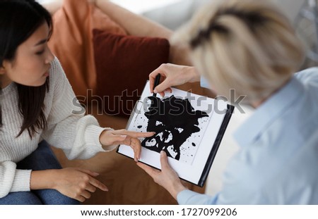 Psychology Test. Psychotherapist Testing Female Patient Showing Inkblot Picture During Therapy Session Sitting In Office. Selective Focus