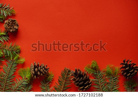 Christmas decorations layout or flatlay with fir branches and cones on red background.Eco natural frame. winter, new year Holidays concept as top view, copyspace. greeting card template Royalty-Free Stock Photo #1727102188