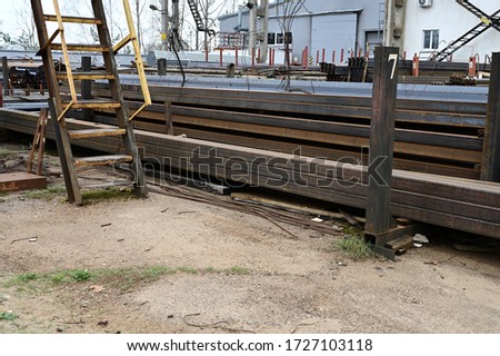Photo of piles of pallets outdoors black metal lie
