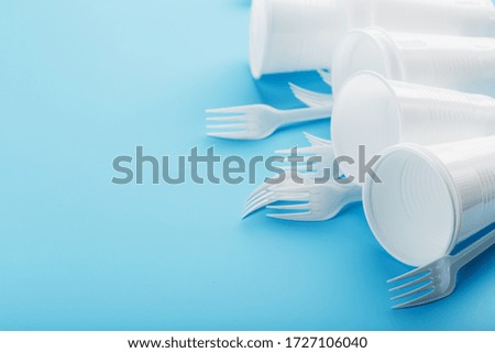 Dishes made of white plastic on a blue background.