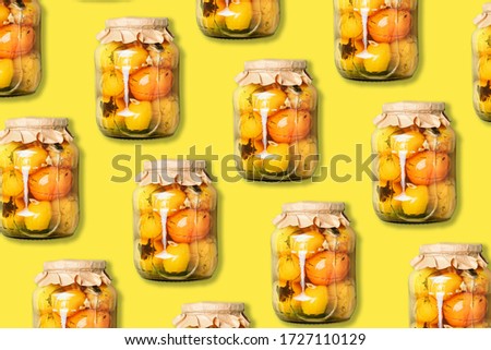 Pickled tomatoes in jar pattern on yellow background. Top view. Creative packing design. Canned and preserved vegetables. Ingredients for vegetables preserving. Healthy fermented food concept