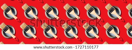Brush and open paint can pattern on red background. Top view, copy space. Creative design for packaging. Appartment renovation, repair, building and home design concept