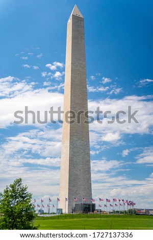 Washington monument on sunny day with blue sky background.