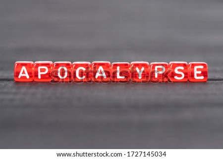 Apocalypse word on cubes on black background. War destruction concept, nature catastrophe