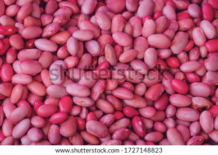 Red beans texture background from the top view. Healthy fresh red beans in a greenhouse on an organic farm. Royalty high-quality free stock image of beans. Nature photography.