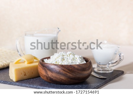 Food is a source of calcium, magnesium, protein, fats, carbohydrates, balanced diet. Dairy products on the table: cottage cheese, sour cream, milk, cheese, contain casein, albumin, globulin, lactose Royalty-Free Stock Photo #1727154691