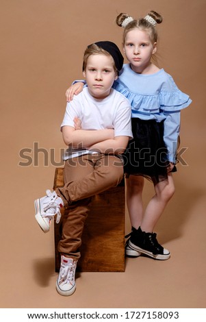 sad boy and girl on a beige background