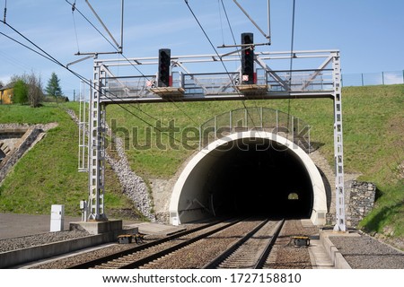 Railway and railroad track is goint into dark and long tunnel. Infrastructure building and underground passageway. Royalty-Free Stock Photo #1727158810