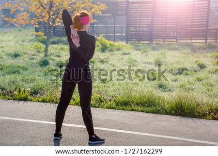 Photo of young european woman on a street workout in sports park on sunny day. Concept of training outdoor.