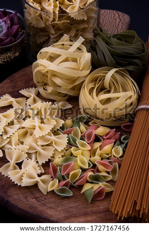 Different types of pasta: tagliatelle, conchiglie, farfalle and linguine.