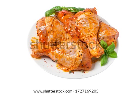 Raw chicken marinated drumstick or legs in a plate with herbs and spices isolated on white background. close up Royalty-Free Stock Photo #1727169205