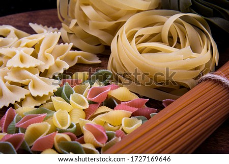 A bond of linguine, farfalle, tagliatelle and colorful conchiglie pasta.