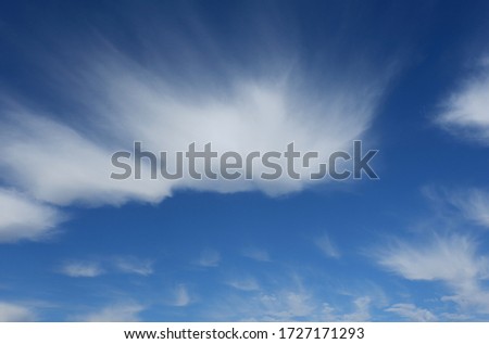 Cirrus spindrift clouds against blue sky, forming interesting picture in high layers of  atmosphere. Formed by the Cierzo wind, characteristic of Aragon region and city of Zaragoza