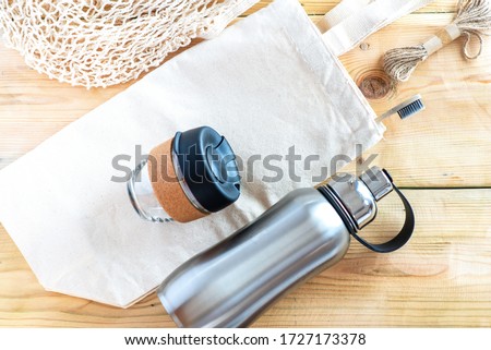 Eco friendly shopping bags, reusable coffee cup, reusable water stainless bottle, bamboo toothbrush and skein of jute twine. Sustainable lifestyle. Plastic free and zero waste concept.