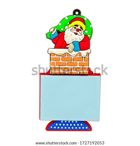 Isolated close up view of magnet Christmas Stick note on white background. Light blue empty paper sheet