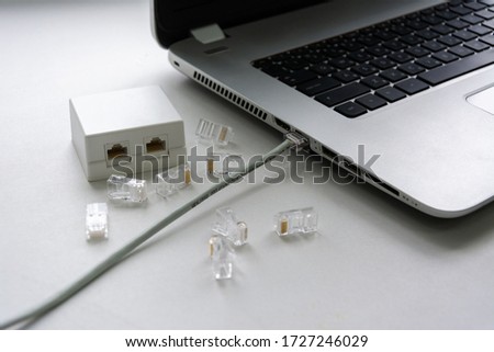 Ethernet cable twisted pair connected to a laptop, connectors and Internet outlets