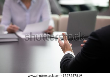 During board meeting partners solve issues, rear view ceo close up focus on his hands, express professional opinion, offer solutions based on experience and competence. Job interview process concept Royalty-Free Stock Photo #1727257819