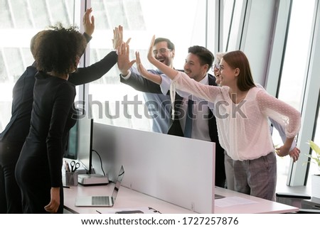 Group of diverse co-workers making profitable deal giving high five share common success celebrating victory moment, received great news about company leadership, team of lawyers won the case concept Royalty-Free Stock Photo #1727257876