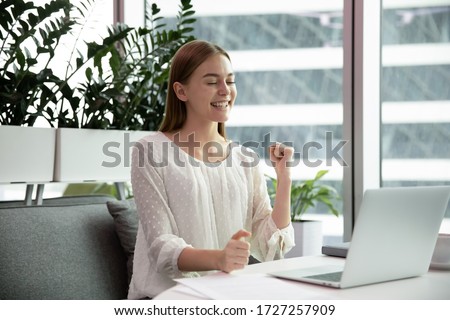 Female office worker got great news feels overjoyed. Businesswoman clenched fist make Yes gesture receive fantastic business opportunity. Successful employee, sales increase career advancement concept Royalty-Free Stock Photo #1727257909