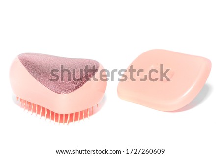 Pink detangling Brush on a white background. pink comb.