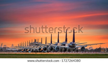 Commercial airplane parking at the airport are stopped effect by covid-19 pandemic around the world economic down crisis, Airplanes are parking at maintenance area because of COVID-19 travel alert Royalty-Free Stock Photo #1727264380