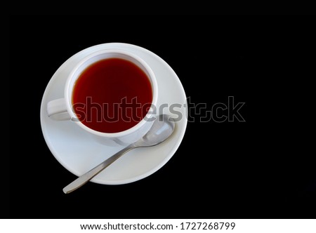 Herbal tea in a white mug on a black background. Suitable for advertising backgrounds and mockups