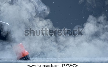 Steam close-up. Steam carpet cleaning on blue background. Home cleaning. Photo with copy space. Royalty-Free Stock Photo #1727297044