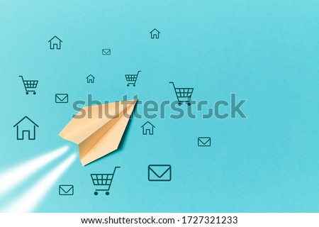Social media marketing. SMM promotion and e-marketing. Paper plane and trolley, house, email signs isolated on blue