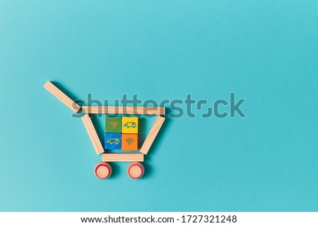 Online delivery service. E-store. On-line supermarket. E-shopping. Colourful wooden cubes in trolley. Truck, wifi signs