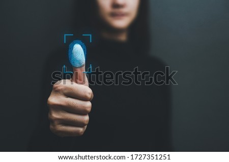 Touch screen, fingerprint scanner, biometric identity of a woman's hand in a blurred background . Royalty-Free Stock Photo #1727351251
