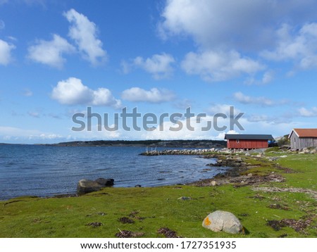 Burgundy wooden houses and landscapes in the Koster, Sydkoster and Nordkoster islands. Archipielago of Kosterhavets Nationalpark. Stromstad. Bohuslan. Sweden. Royalty-Free Stock Photo #1727351935