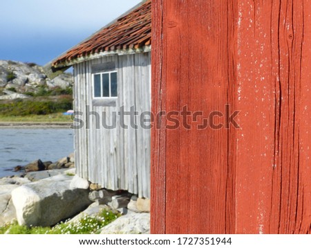Burgundy wooden houses and landscapes in the Koster, Sydkoster and Nordkoster islands. Archipielago of Kosterhavets Nationalpark. Stromstad. Bohuslan. Sweden. Royalty-Free Stock Photo #1727351944