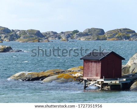 Burgundy wooden houses and landscapes in the Koster, Sydkoster and Nordkoster islands. Archipielago of Kosterhavets Nationalpark. Stromstad. Bohuslan. Sweden. Royalty-Free Stock Photo #1727351956