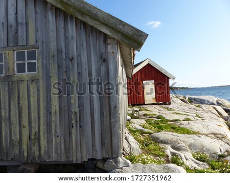 Burgundy wooden houses and landscapes in the Koster, Sydkoster and Nordkoster islands. Archipielago of Kosterhavets Nationalpark. Stromstad. Bohuslan. Sweden. Royalty-Free Stock Photo #1727351962