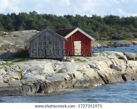 Burgundy wooden houses and landscapes in the Koster, Sydkoster and Nordkoster islands. Archipielago of Kosterhavets Nationalpark. Stromstad. Bohuslan. Sweden. Royalty-Free Stock Photo #1727351971