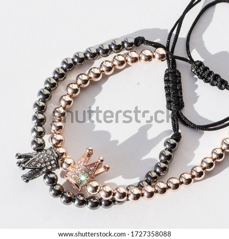Stock Photo - bracelet with little crown on white