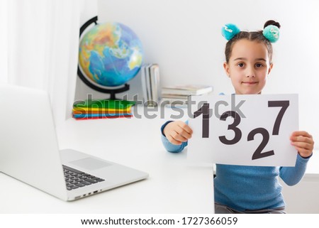 Cute schoolgirl on distance education at home. Education, online distance learning, homeschooling during quarantine at home