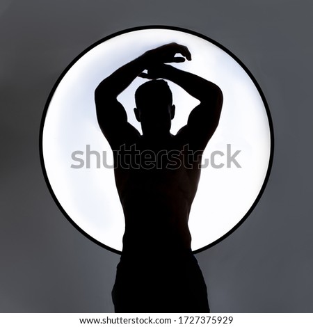 Athlete male silhouette in a circle. Black and white. Perfect body.