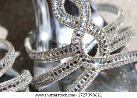 sparkling silver shoes in the sun Royalty-Free Stock Photo #1727398621