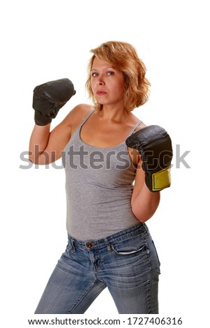 Attractive woman in boxing gear against a white background