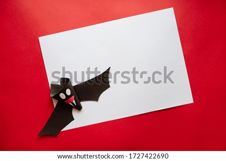 Funny Halloween Bat Made From Paper on a Red Background. Postcard on Helloween