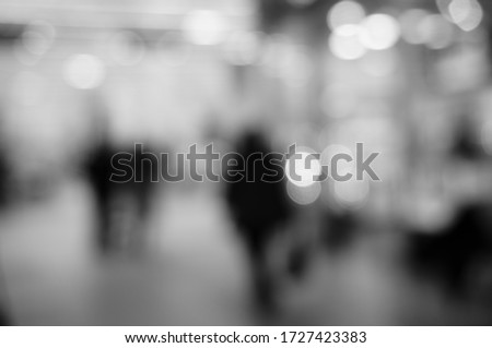Blurred background. People go shopping. Silhouettes of people.