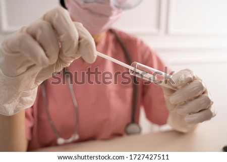 Doctor holding swab test tube for coronavirus Royalty-Free Stock Photo #1727427511