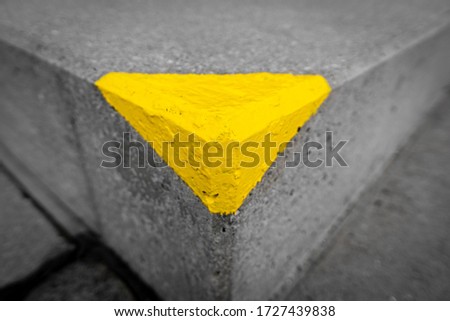 Corner painted with yellow triangle