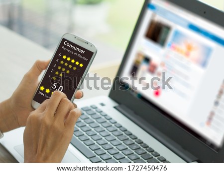 A woman presses a button to evaluate services for online shopping on a virtual touch screen on a smartphone. Customer service evaluation concept Royalty-Free Stock Photo #1727450476