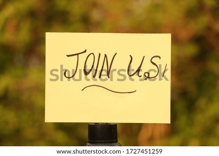 Handwriting text join us isolated on outdoor background