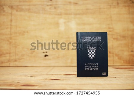 Croatian passport on a wooden background