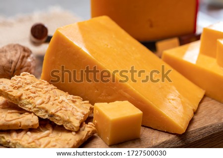 British red waxed yellow cheddar cheese and crackers with grated cheese