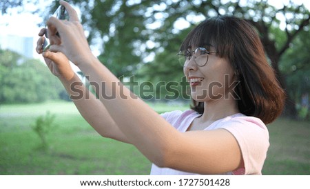 An Asian girl is taking a natural view in the garden.