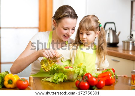 Happy woman and child preparing healthy food together
